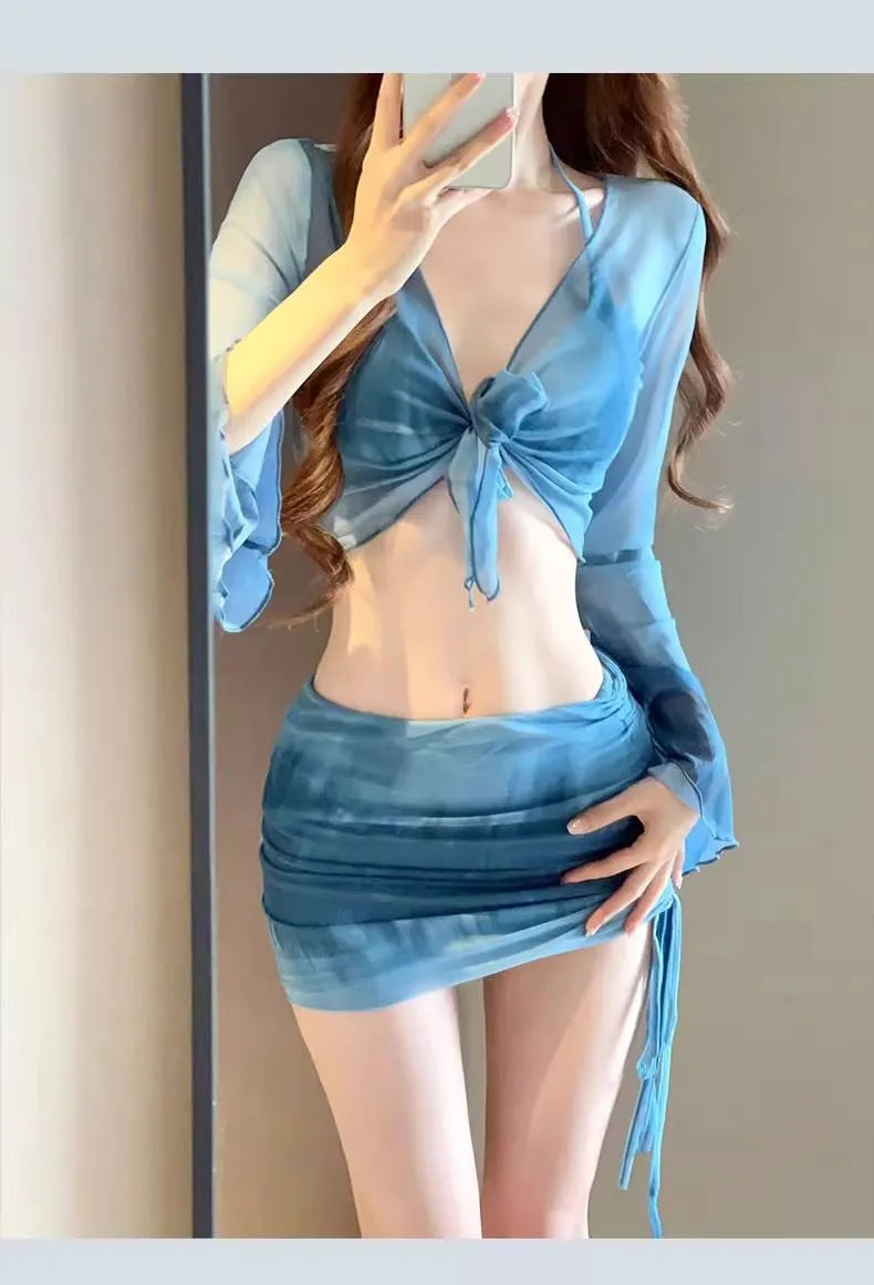 Women's blue four-piece bikini set with high-waist briefs, backless top, and coordinating skirt