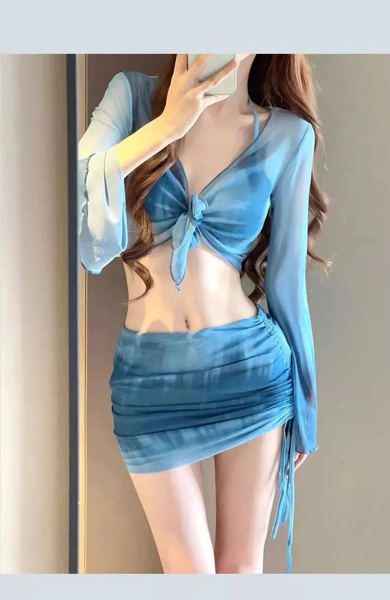 Women's blue four-piece bikini set with high-waist briefs, backless top, and coordinating skirt