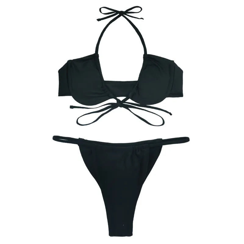 Women's black and mint green two-piece nylon bikini swimsuit laid flat