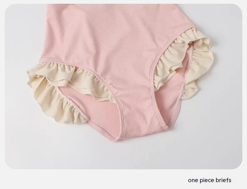 Pink women's one-piece swimsuit with Siamese design on a mannequin.