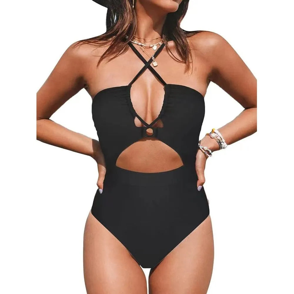 Women's black cross-back one-piece swimsuit with backless design and solid colour pattern