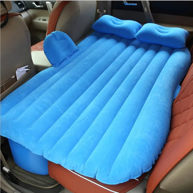 Black inflatable car bed with flocking surface and two pillows, shown folded next to a storage bag.