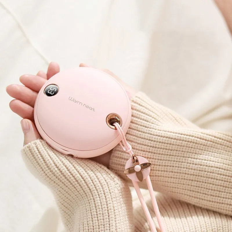 Green hand warmer power bank with digital display showing battery percentage and temperature settings