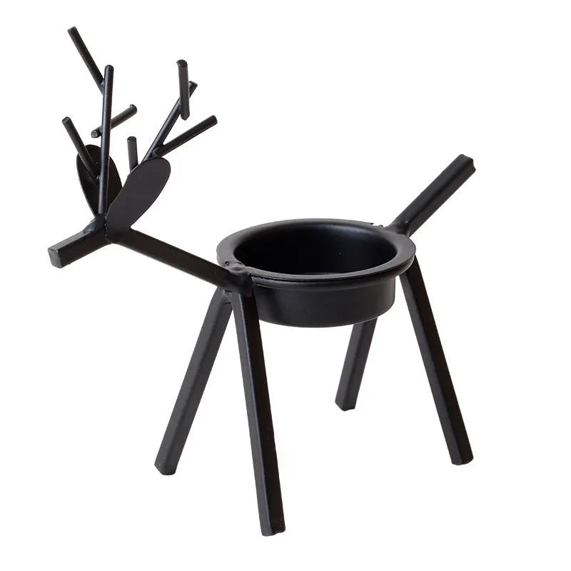Black iron Christmas candlestick holder with decorative elk antler design.