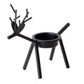 Black iron Christmas candlestick holder with decorative elk antler design.