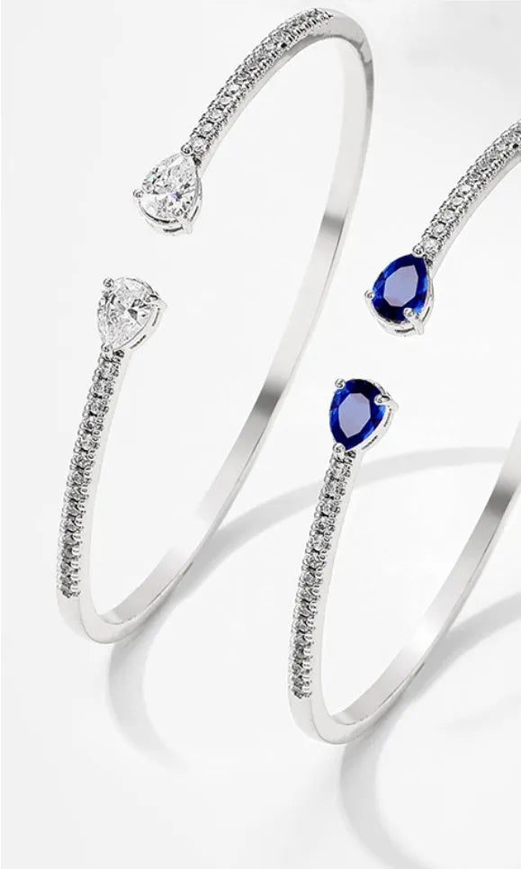 Copper bracelet with zircon inlay in white or blue colour simple design