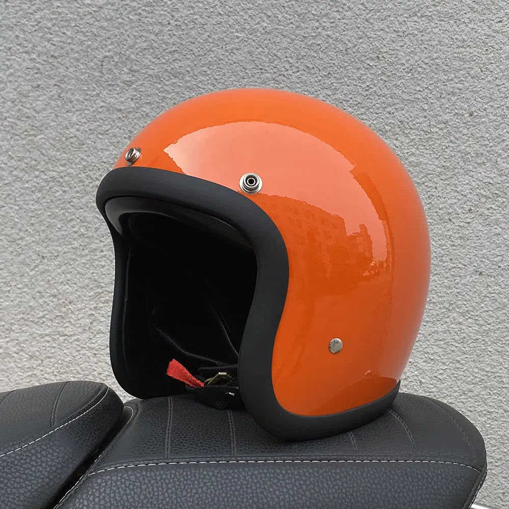 A cement grey retro-style motorcycle half helmet with a floral pattern on the side, showing its open-face design.