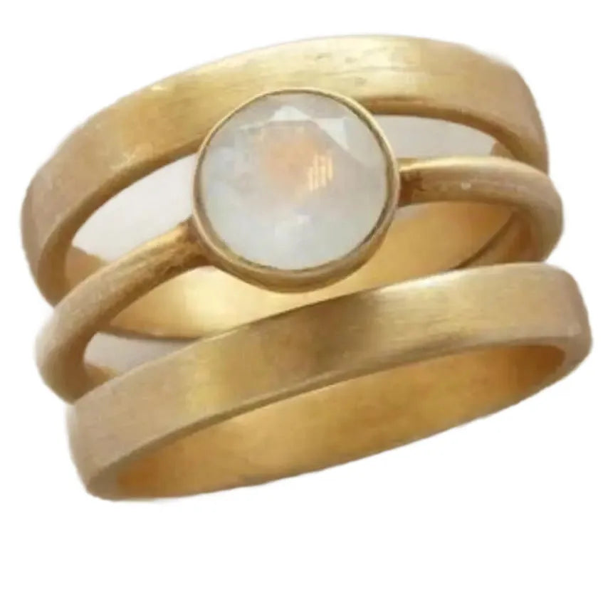 Gold geometric ring with a white chalcedony stone set using hollow micro-inlay technique.