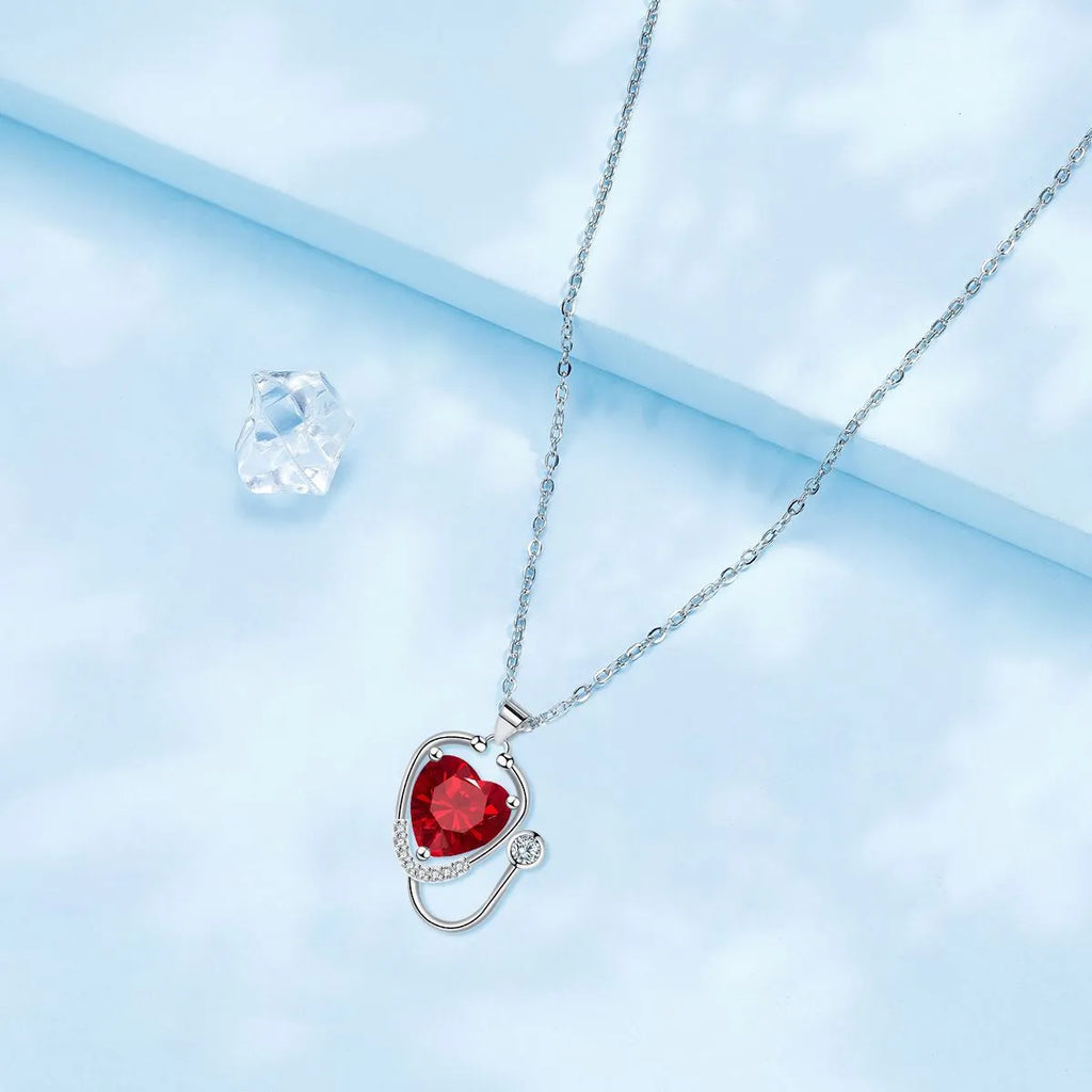 Women's red diamond stethoscope necklace with wings and cross motifs on copper chain