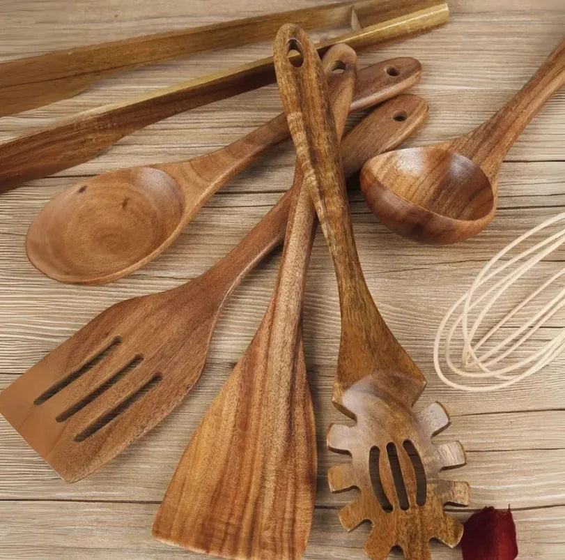 7-piece beechwood cooking utensil set including wooden spoon, spatula, ladle, and pasta fork on kitchen counter