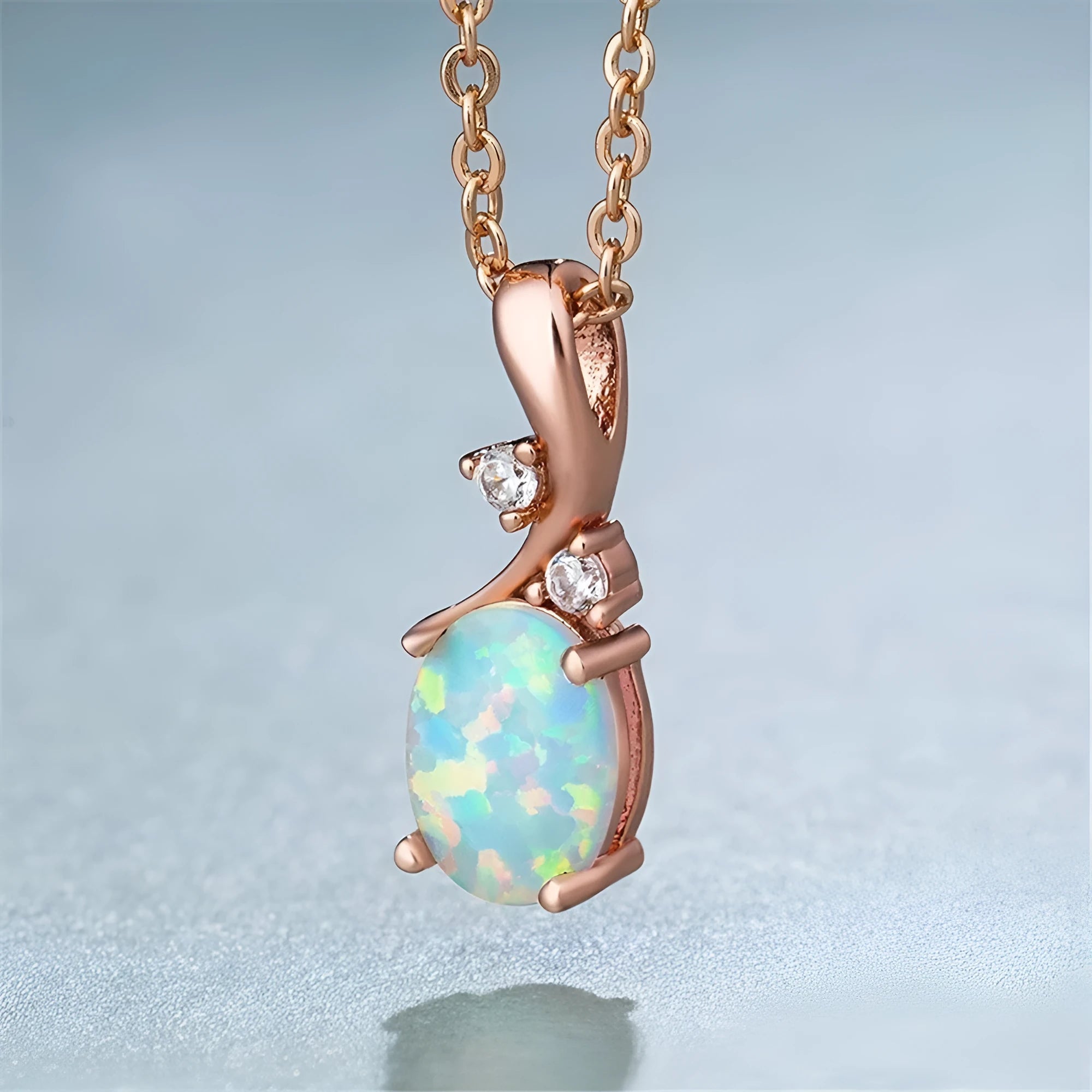 Water drop shaped opal pendant necklace with adjustable O-chain in rose gold or white electroplated finish.