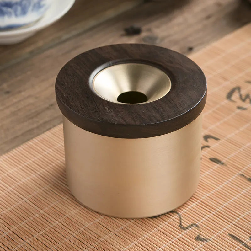 Retro brass ashtray with wooden lid showing copper construction and central hole design