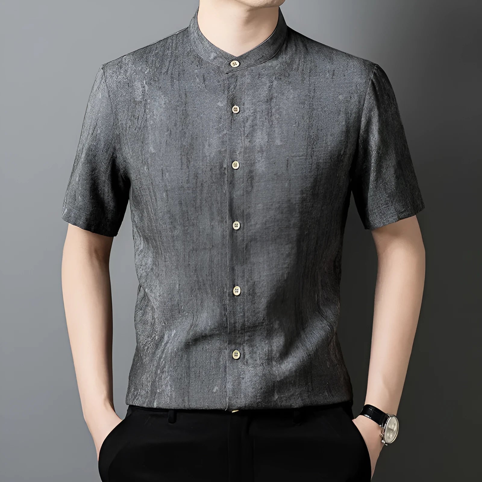 Men's loose grey linen cardigan shirt with a stand collar on a hanger.