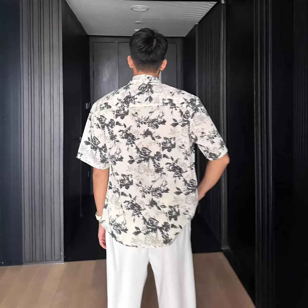 Loose casual short sleeve shirt with floral printed pattern and V-neck design in white colour