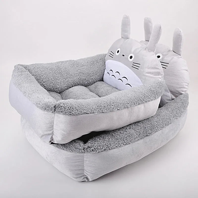 Blue cartoon-style sofa pet bed with a removable padded cushion for a small dog or cat.