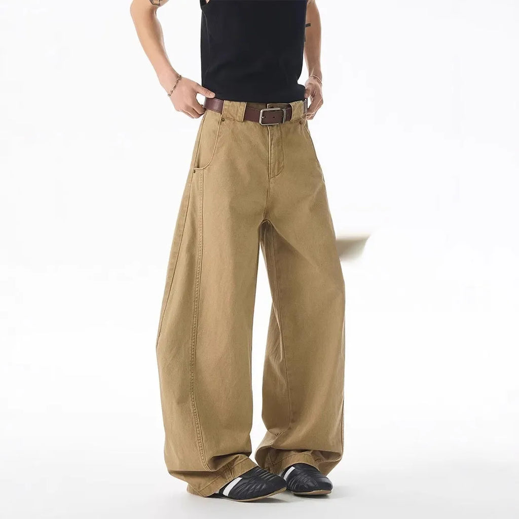 Brown men's loose-fit denim jeans with a straight leg and button fly on a neutral background.