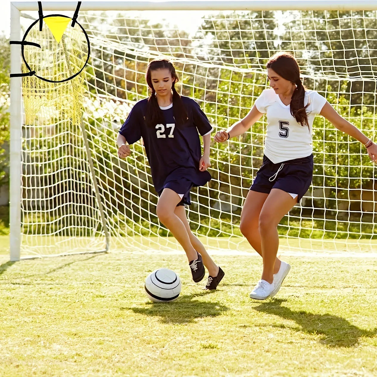 Portable black and yellow soccer training goal net set up on a grass field.