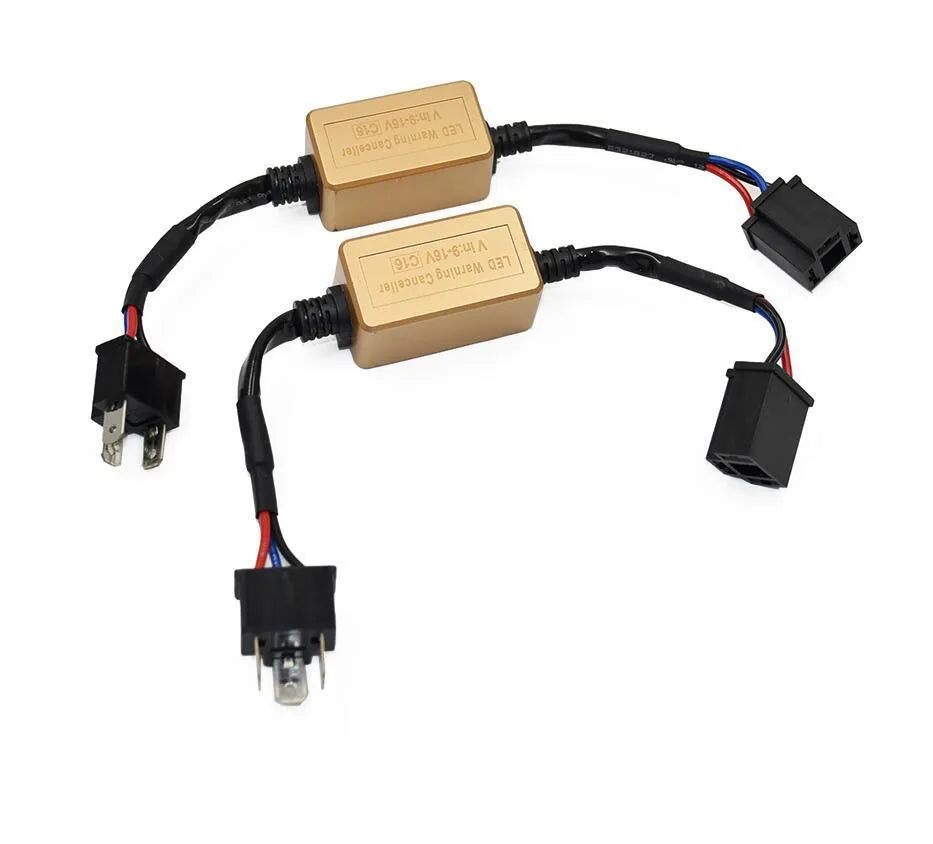 Black alloy LED Canbus decoder for H4 H7 H11 car headlight bulbs on a white background.