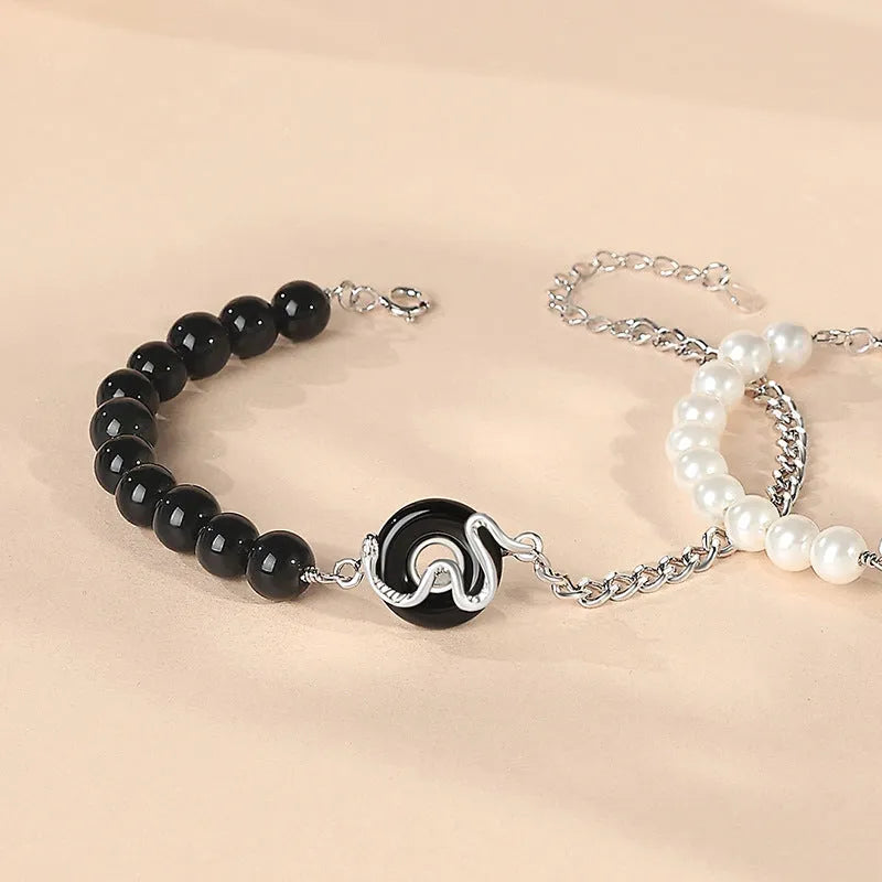 925 sterling silver couple bracelet with snake design, obsidian pearls, and a safe buckle.