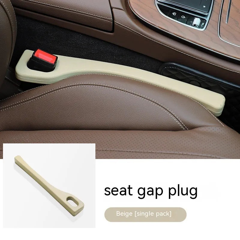 A flexible polyurethane car seat gap filler strip in black, placed between a car seat and centre console.
