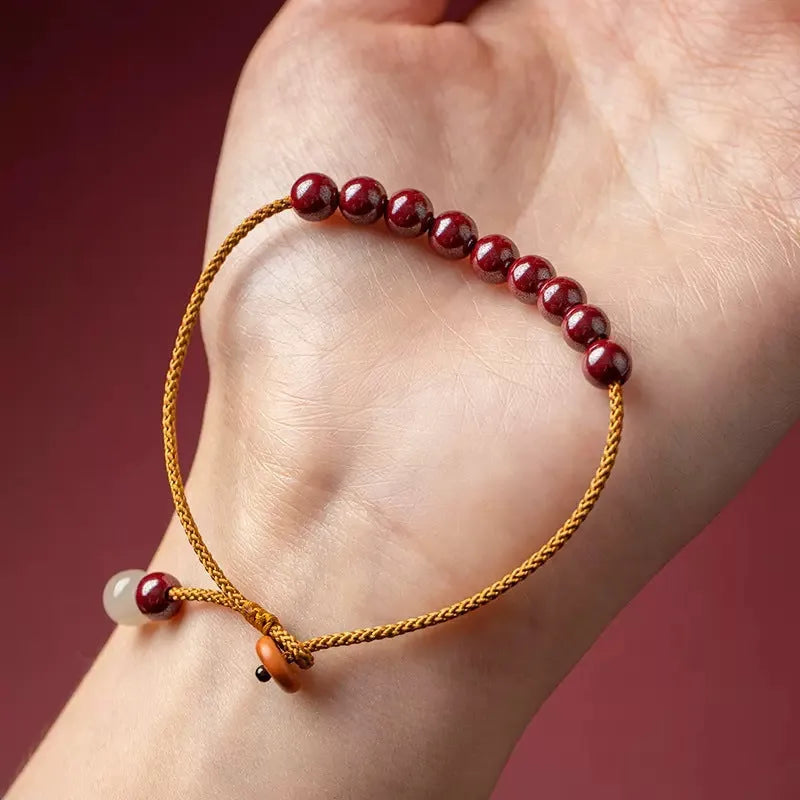 Hand-woven raw ore cinnabar bracelet with Hetian jade accents in a geometric design.