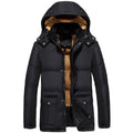 Man wearing a black double-breasted velvet padded hooded winter jacket.