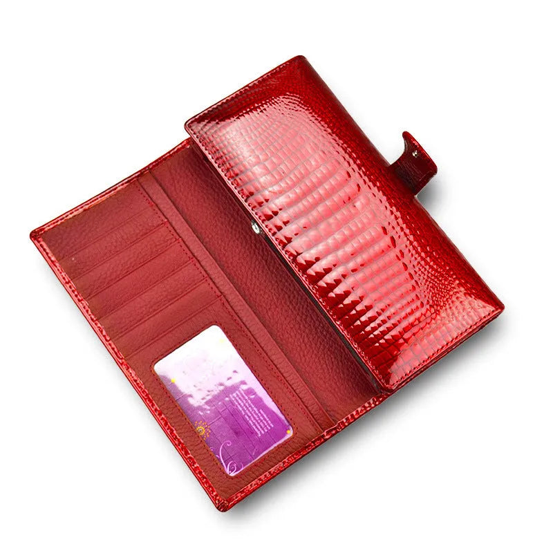 Women's red leather coin purse with a textured crocodile pattern, shown open to reveal pigskin lining.