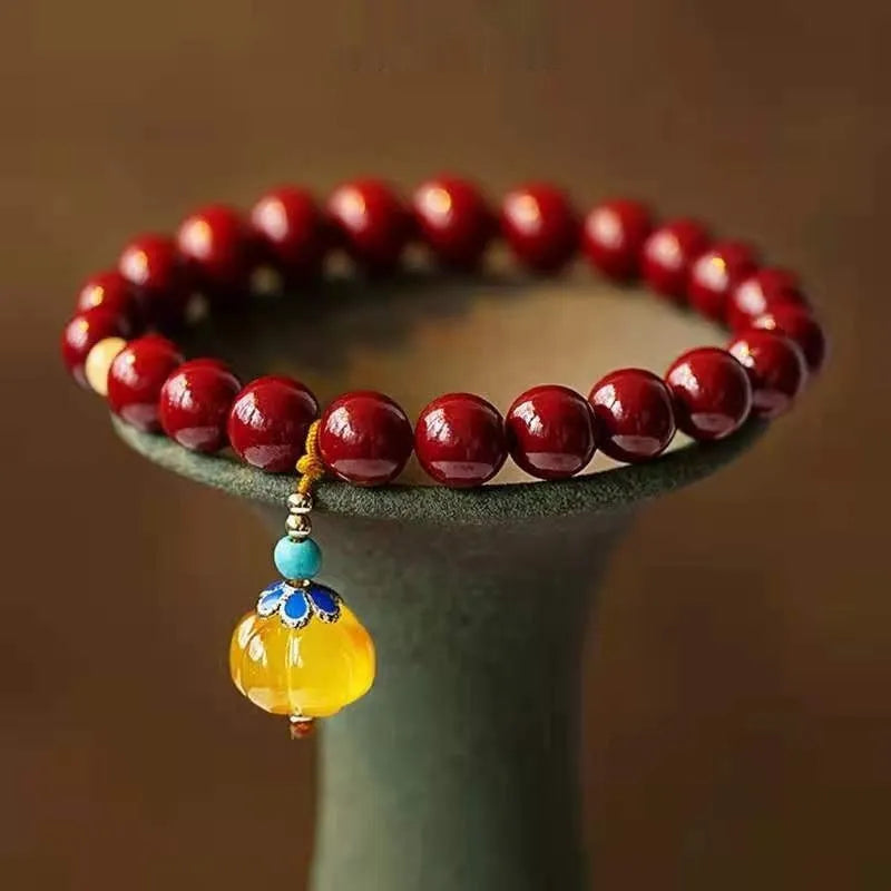 Gold cinnabar bracelet with wave design and copper beads in traditional Chinese style