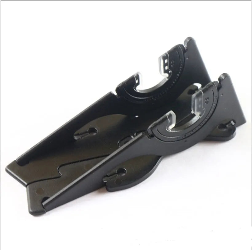 Black plastic card-type mobile phone holder on a wooden desk