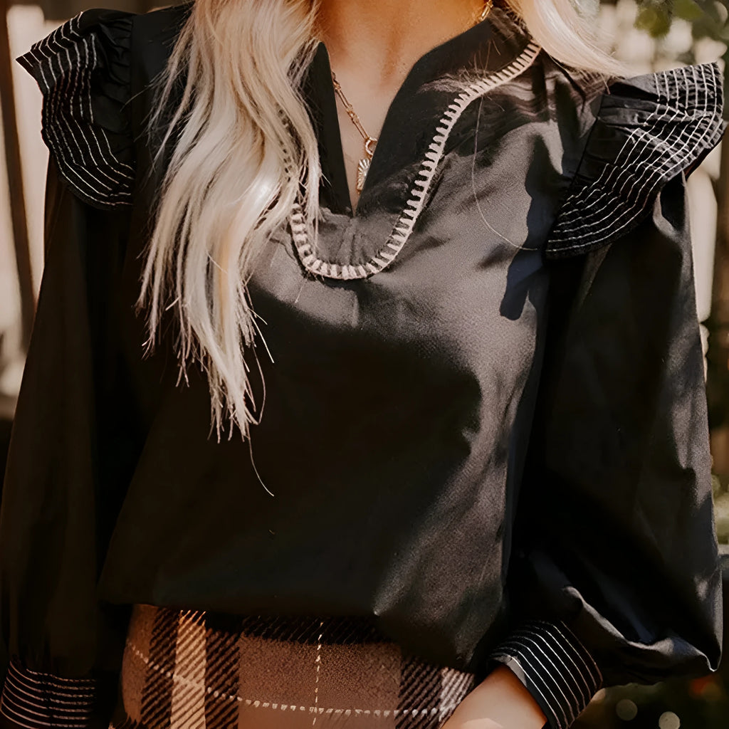 Black women's V-neck blouse with long ruffle-trimmed sleeves and contrast stitching