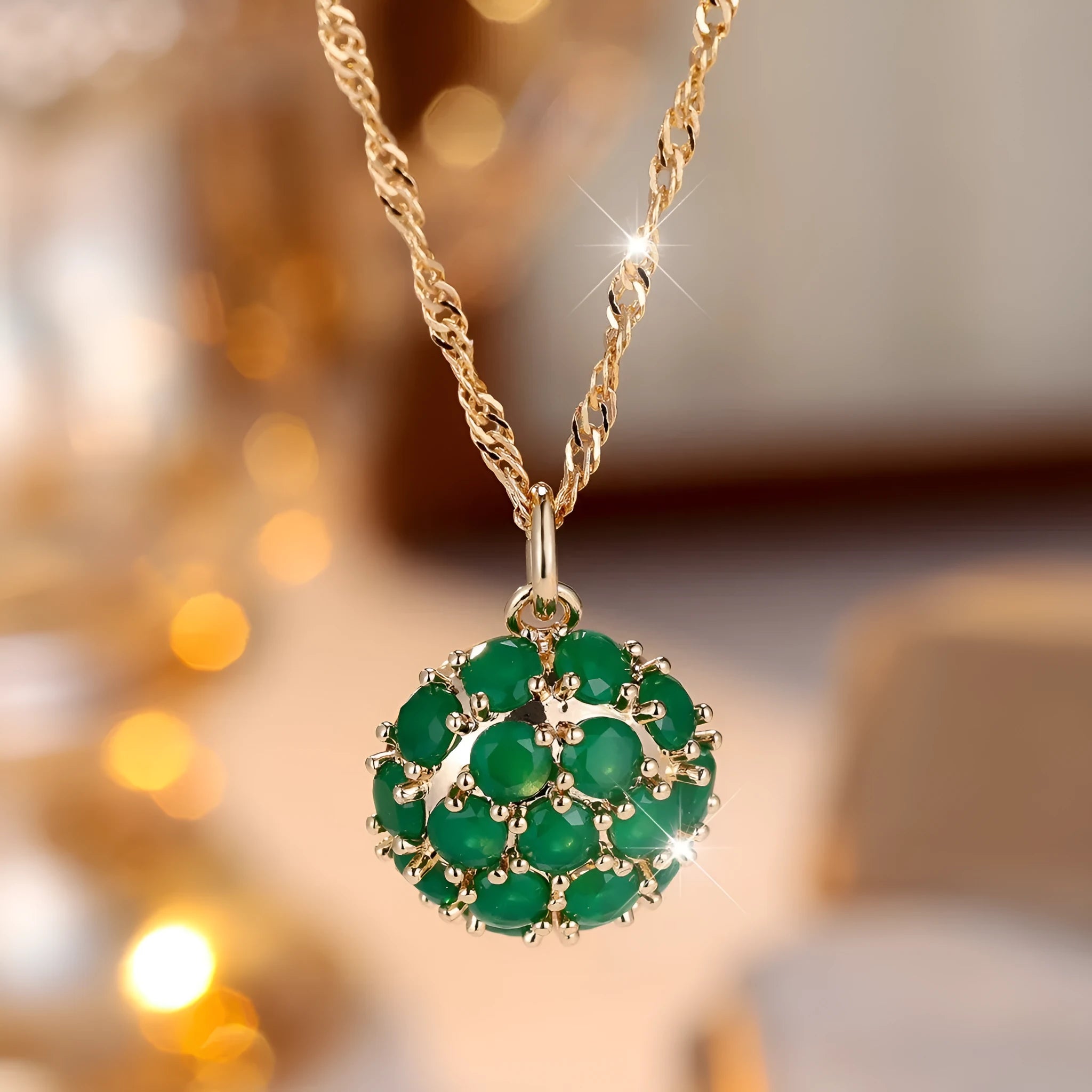 Champagne gold geometric pendant necklace with a round emerald stone and diamond accents on an adjustable chain.
