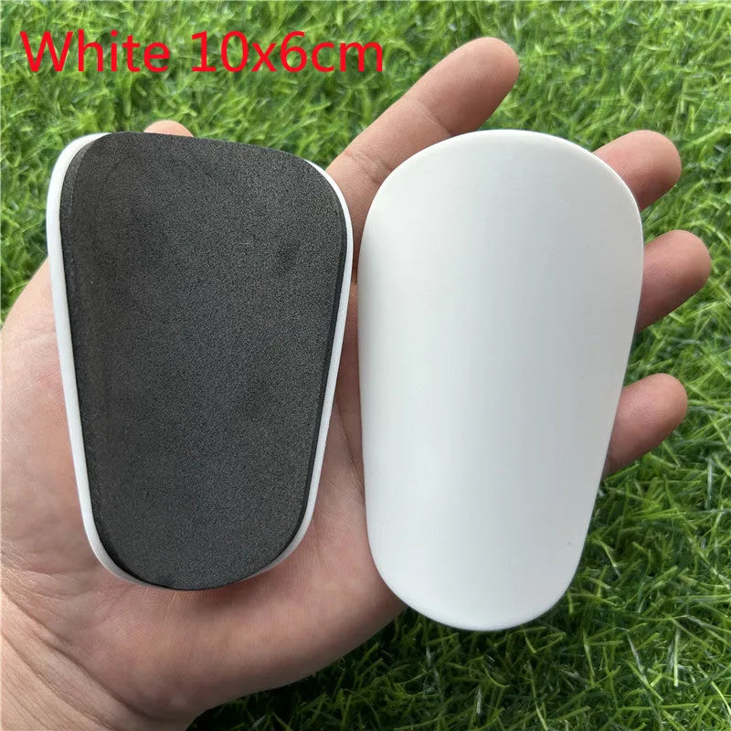 Extra small mini football shin guards in black and white plastic construction