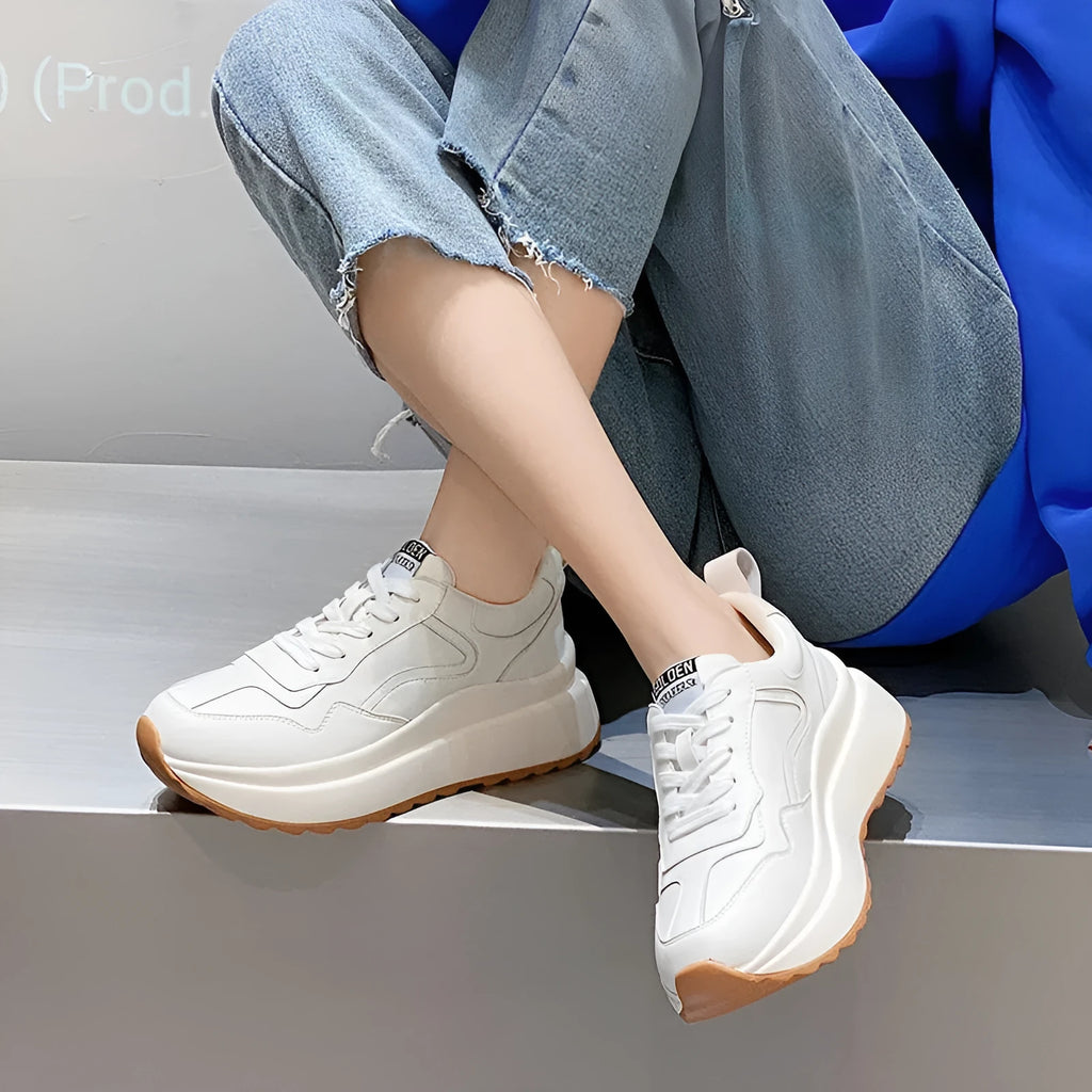 Beige women's low-top leather shoes with cross-strap detail and English muffin heel.