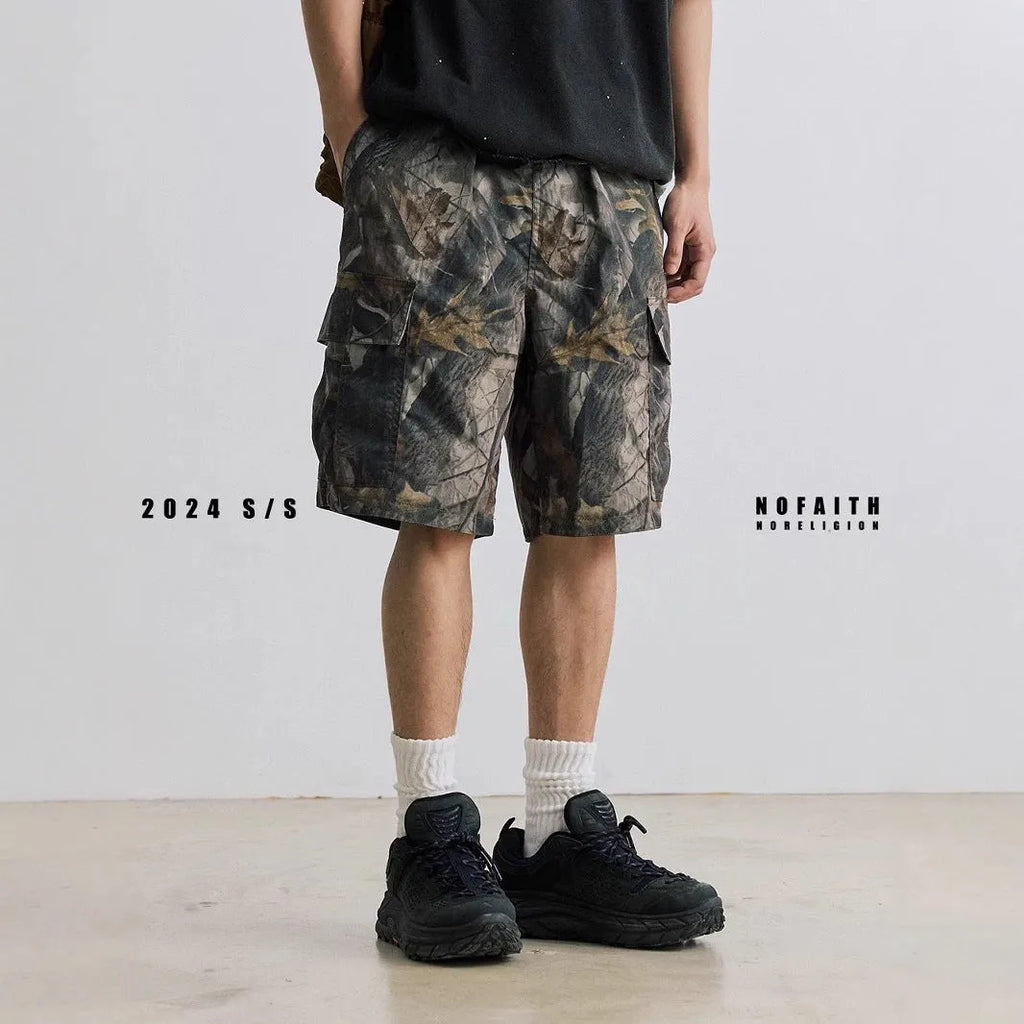 Man's loose straight-leg denim shorts in black on a hanger, showing mid-rise waist and zip fly.