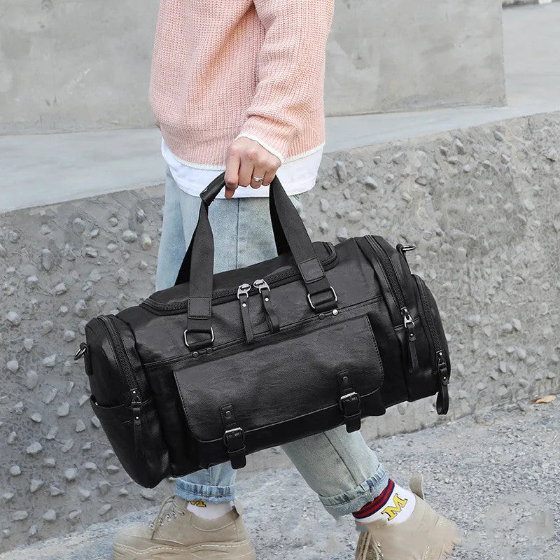 Black PU holdall travel bag with a separate internal compartment for shoes.