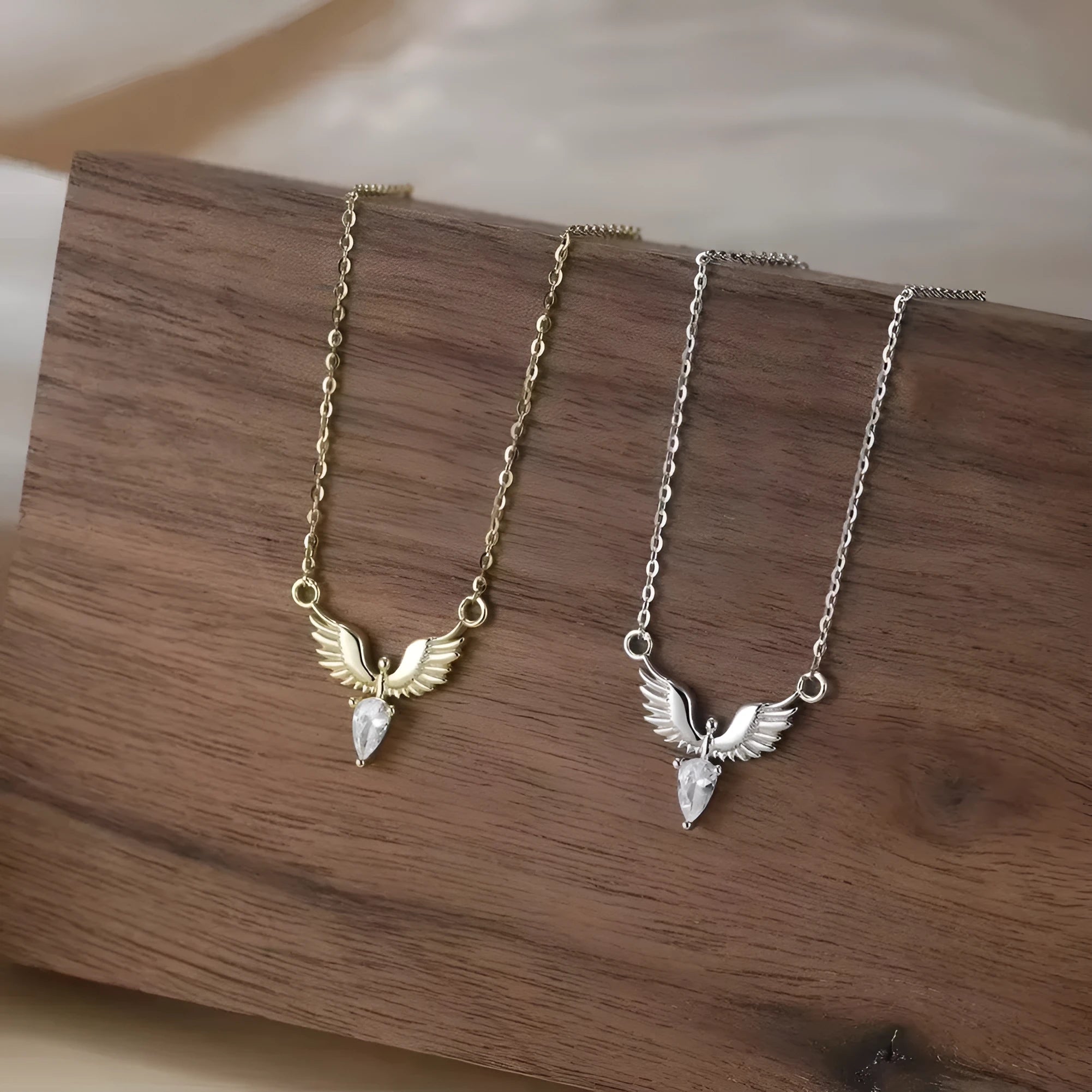 Close-up of an eagle pendant on a silver O-ring chain necklace, showing adjustable length.