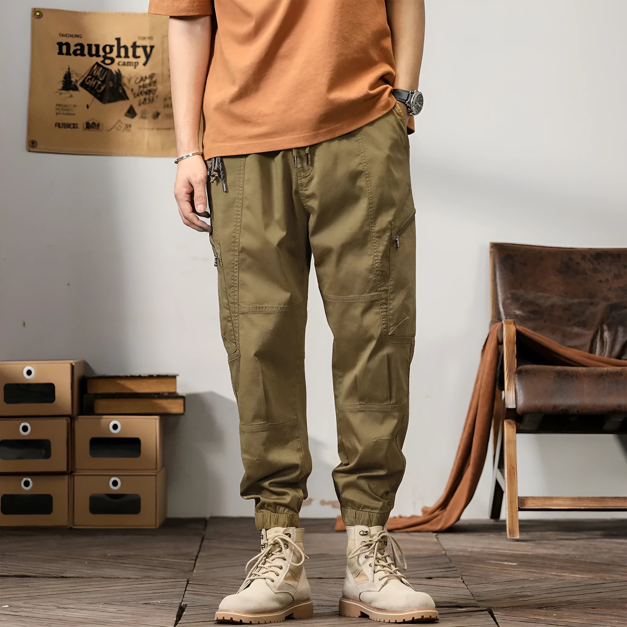 Men's loose khaki cotton harem trousers with tapered leg and ankle banding.