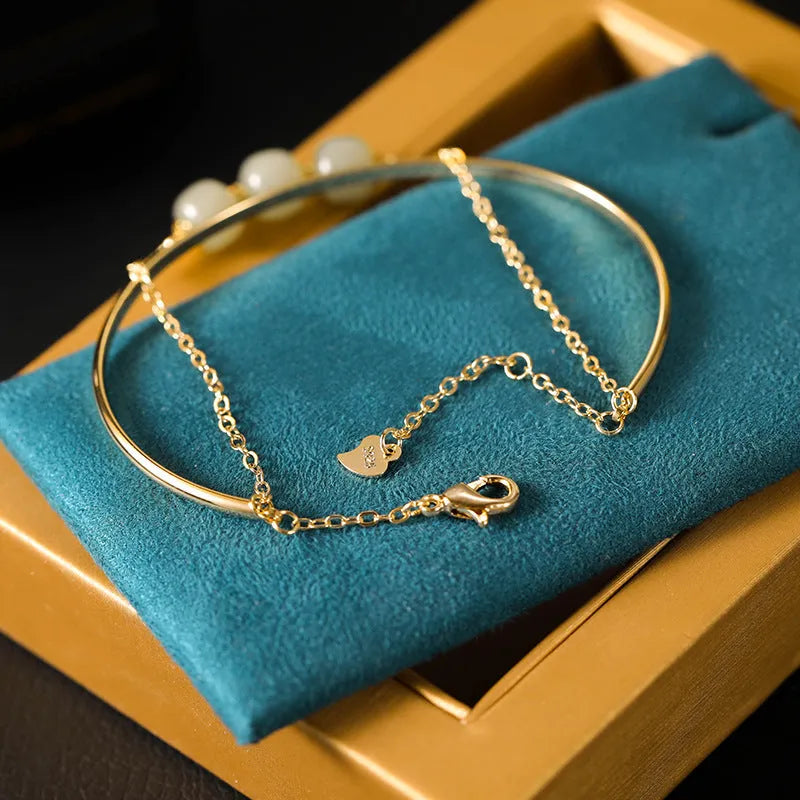 Women's Hetian jade lucky beads bracelet with gold inlay in single, double, and three-bead versions.
