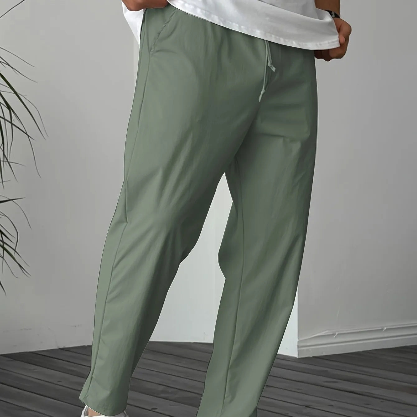 Men's khaki straight-leg drawstring casual trousers with a ribbon pocket detail.