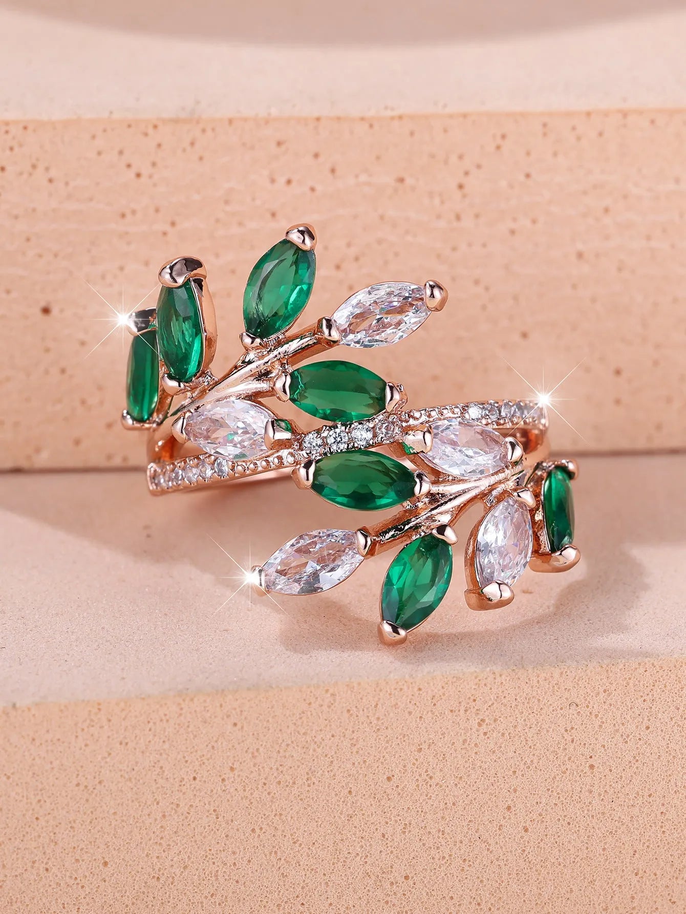 Adjustable horse eye zircon leaf ring in copper on a hand, showing leaf detail and colour options.
