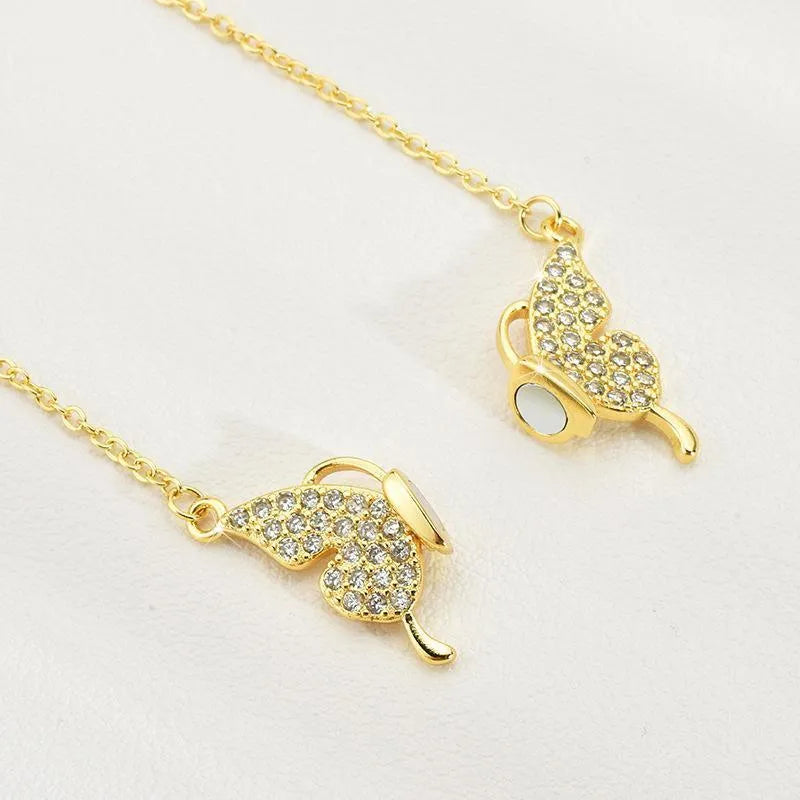 Gold clavicle chain necklace with magnetic butterfly charm and twisted chain design