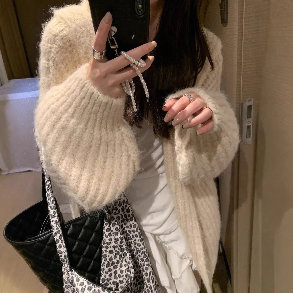A woman's dark grey hooded cardigan with long sleeves, shown open in a loose fit.