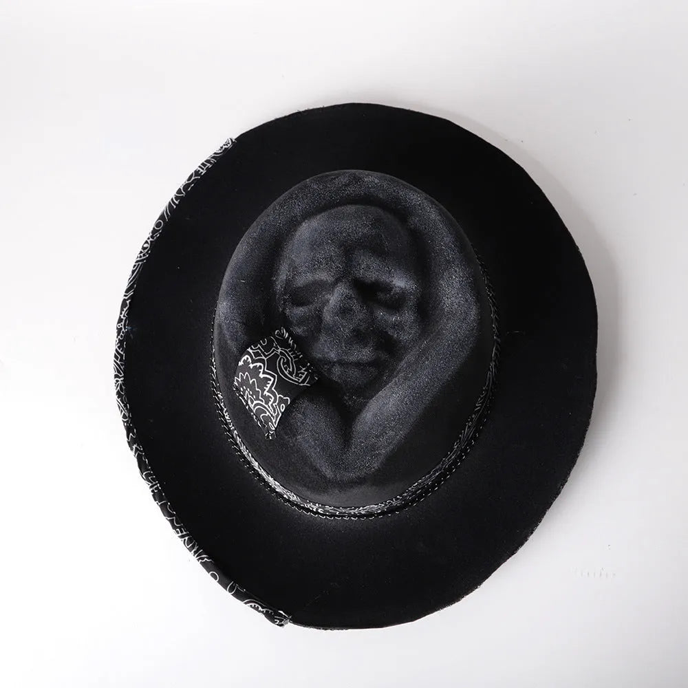 Handmade wool felt denim skull hat with a black conical crown on a white background.