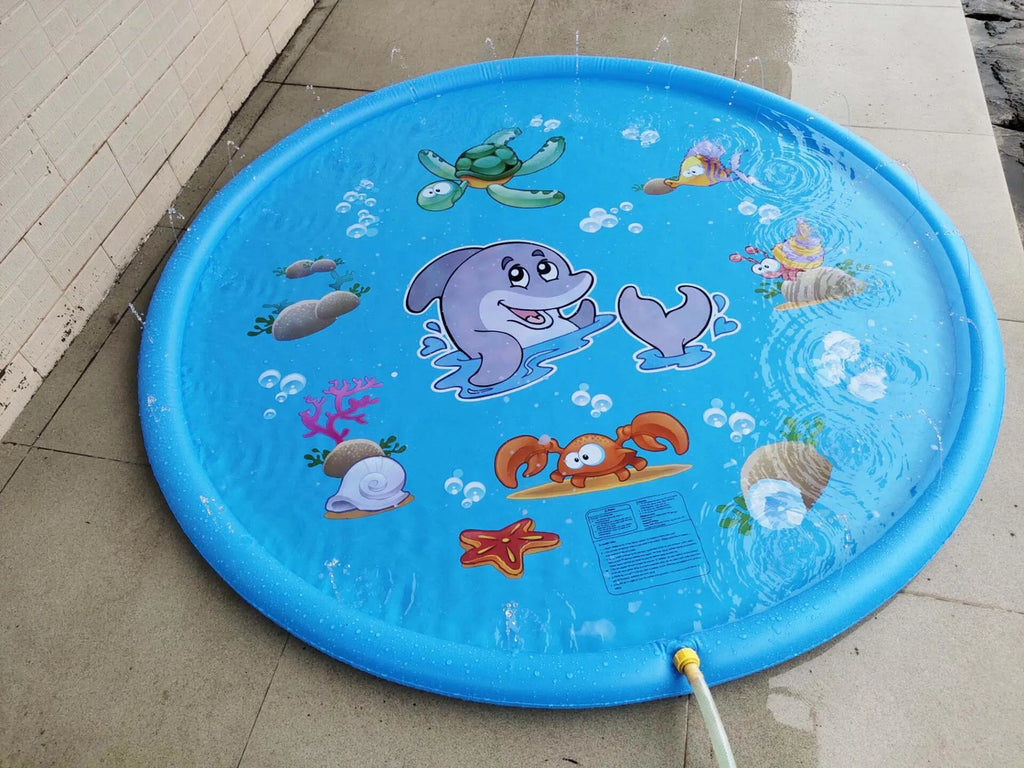 Blue PVC children's water spray mat with marine animal designs laid on grass