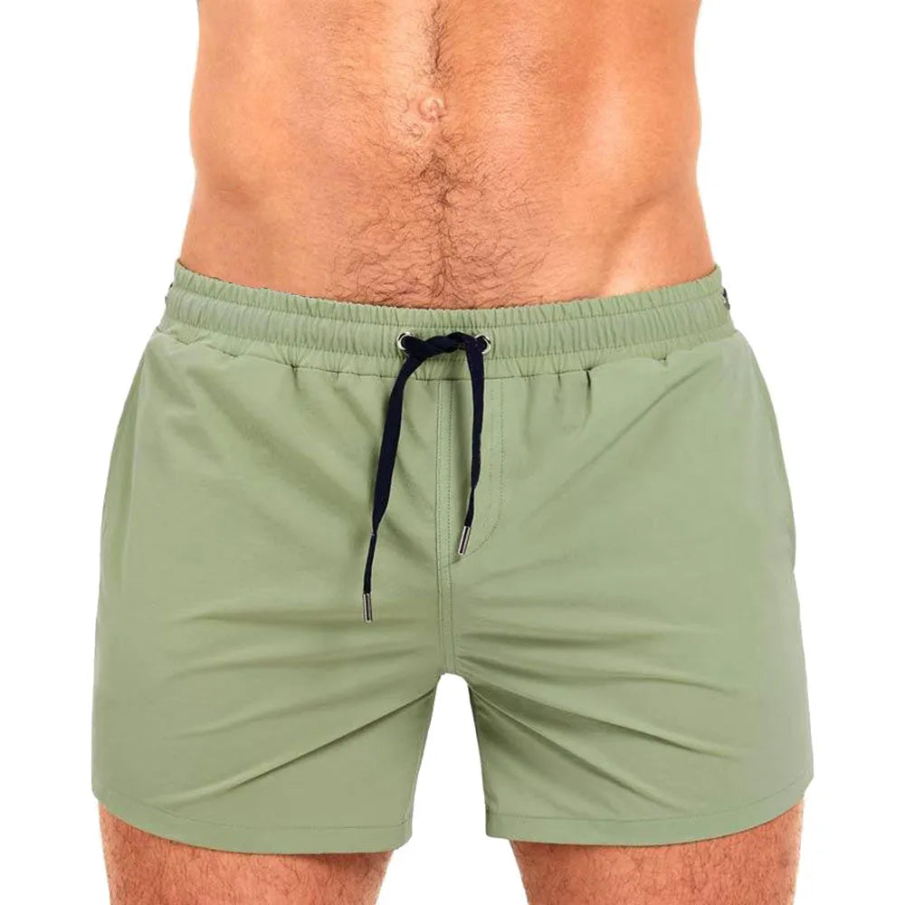 Men's solid colour polyester swimming shorts with mesh lining, shown in multiple colour options.