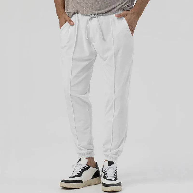 Men's loose tapered casual sweatpants in a grey cotton blend fabric with an elastic waistband.