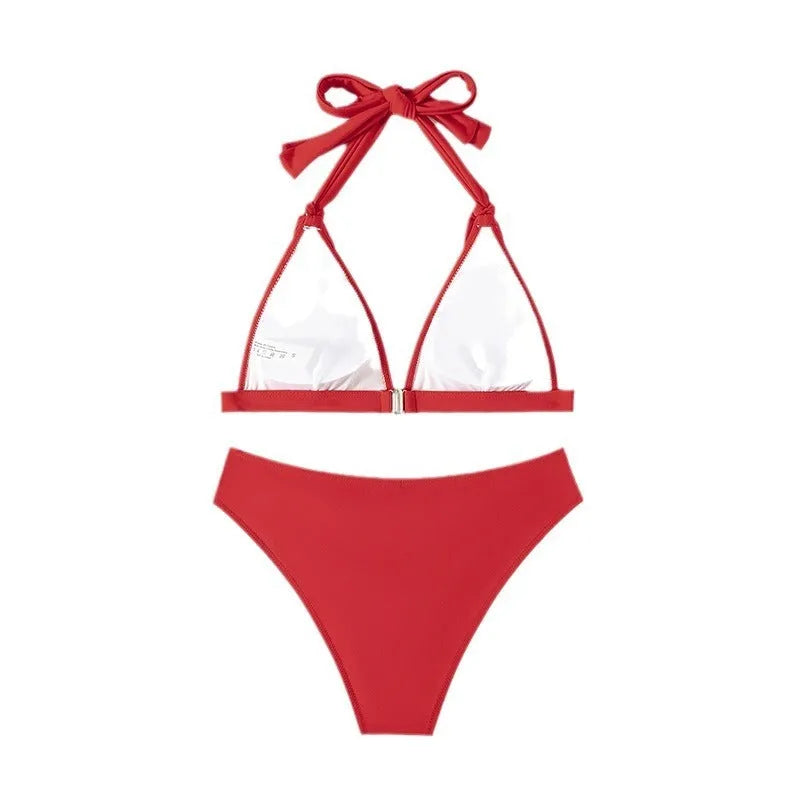 Red women's lace-up halterneck bikini set with split shorts on a mannequin