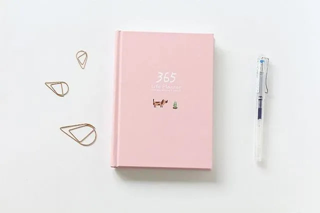 Hardback colour inside notebook planner with 228 pages, open to daily schedule, shown in Dark Green