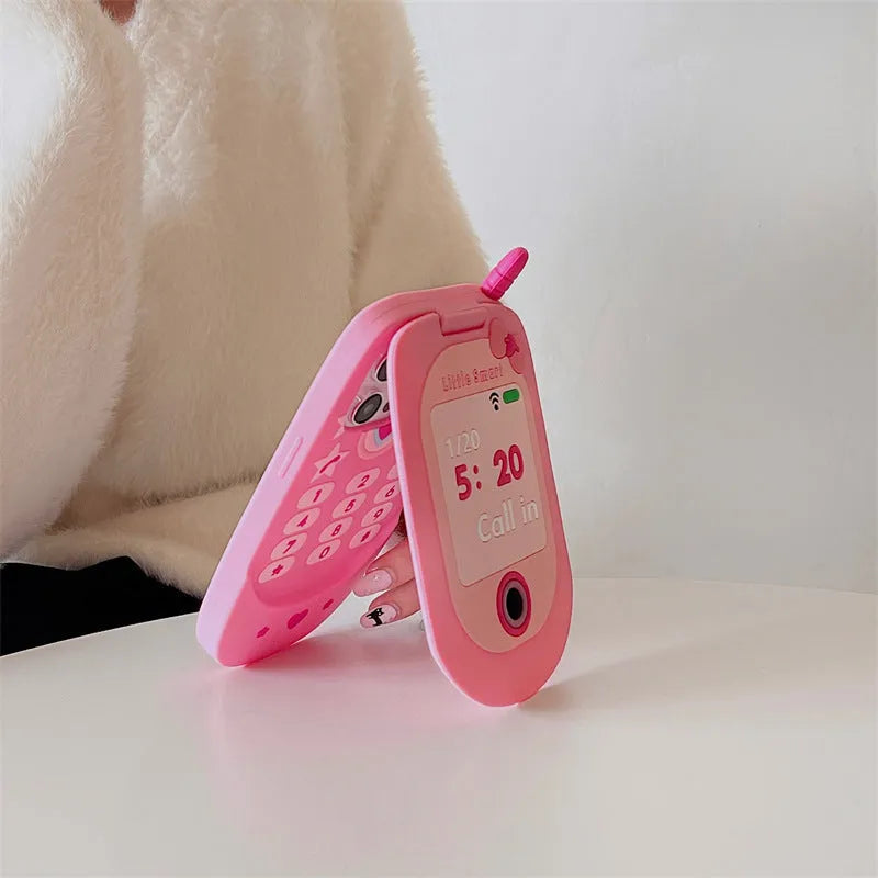 Light pink silicone flip phone case with mirror for iPhone, featuring a cute cartoon design.