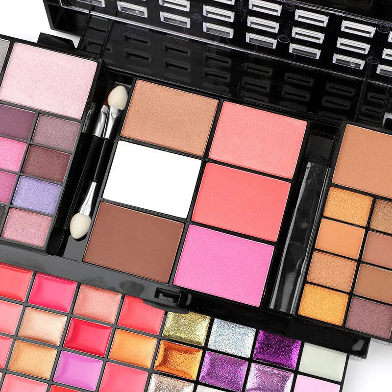 74 colour makeup palette open showing eyeshadows, lip glosses, concealers, blushes, and contour powders with included brushes